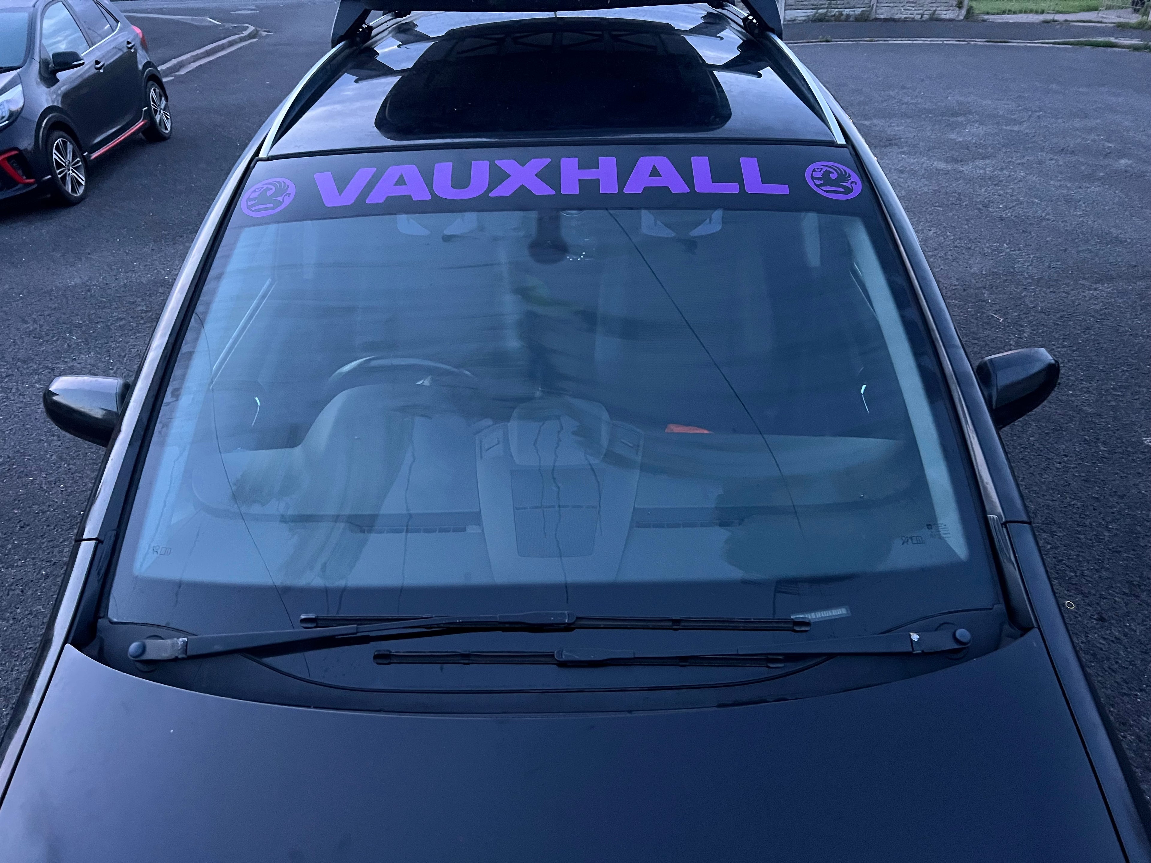 Car with 'VAUXHALL' logo sunstrip